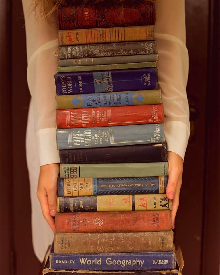 girl holding book stack